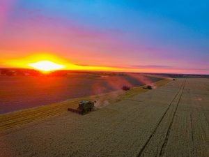 Sunset in the midwest with Harvesters