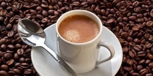 Espresso coffee on coffee beans