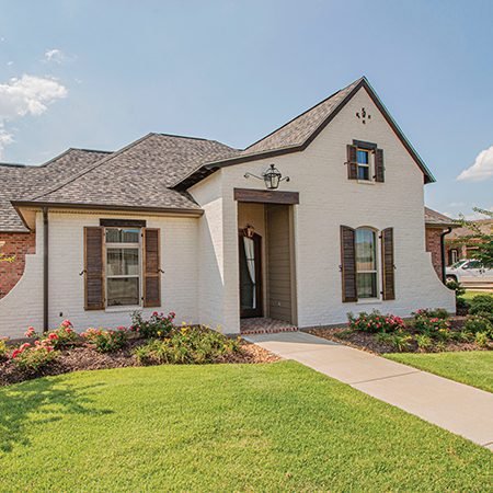 Two story house with well groomed yard are