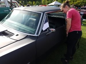 My granddaughter. Mariah, admiring a car built by a 17-year-old girl