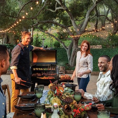 Folks around the grill, readying for a meal