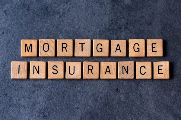 "mortgage,Insurance",Spelled,Out,In,Wooden,Letter,Tiles,On,A