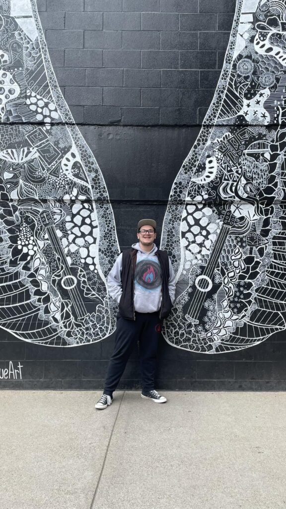 Patrick Cortis with wings behind him