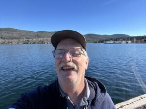 Lee in front of Lake George in November 2024