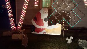 Santa looking at Jesus in the manger