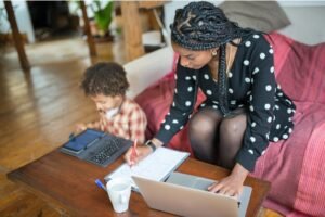 Woman with child working on computer