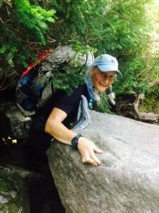 Emily M Leonard standing by a rock on Appalachian Trail