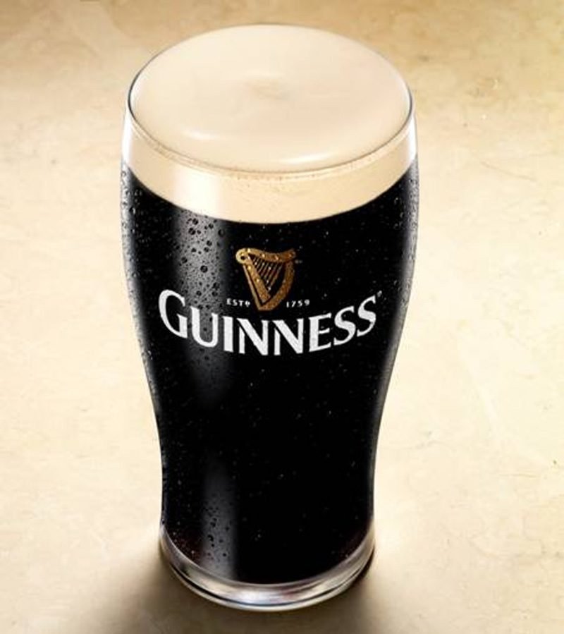 Guinness in a glass with a foamy head