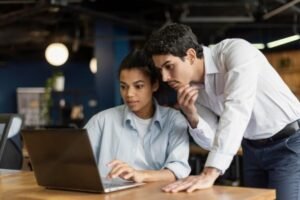 Two people at the laptop