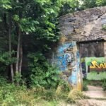 Lost in time – the old water tower stands silently in the woods at the top of the hill, a hidden relic of the past.