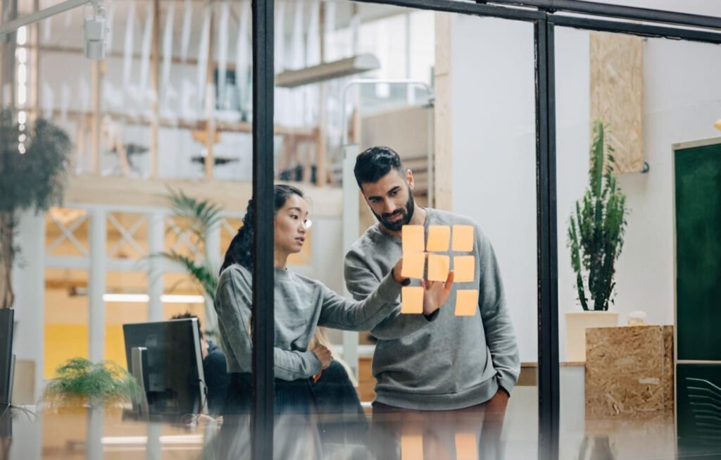 Tech Solutions-Two people standing at window