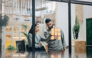Tech Solutions-Two people standing at window